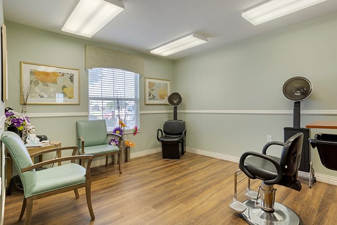 A cozy hair salon with seating and styling areas.