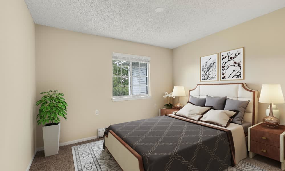 A cozy bedroom with a neatly made bed, decorative pillows, artwork on the wall, and a potted plant by the window.