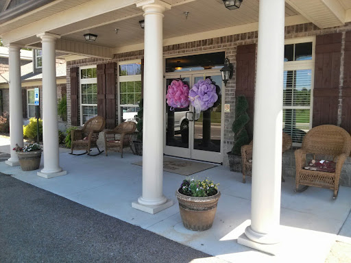 A welcoming entrance featuring decorative flower wreaths and elegant columns.