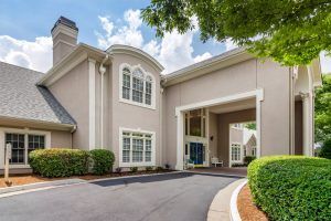 A modern residential building with a welcoming entrance and driveway.