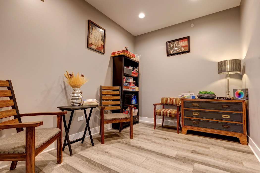 A cozy living room with wooden furniture and a bookshelf.