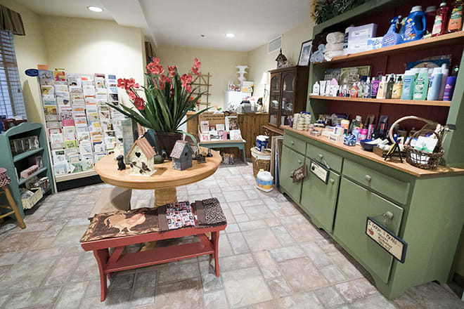 A cozy shop interior with various products displayed on shelves and tables.