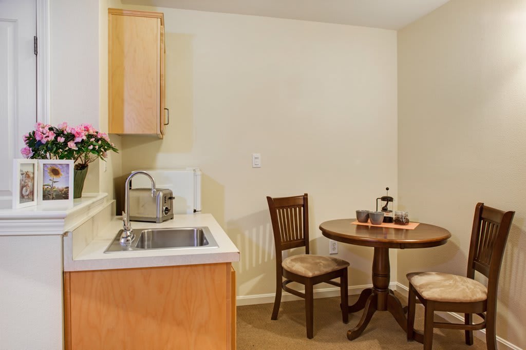 A cozy kitchenette with a small dining table for two.