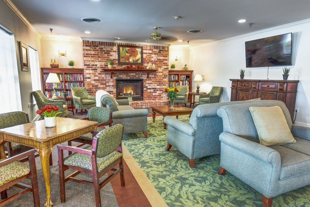 A cozy living room with comfortable seating and a brick fireplace.