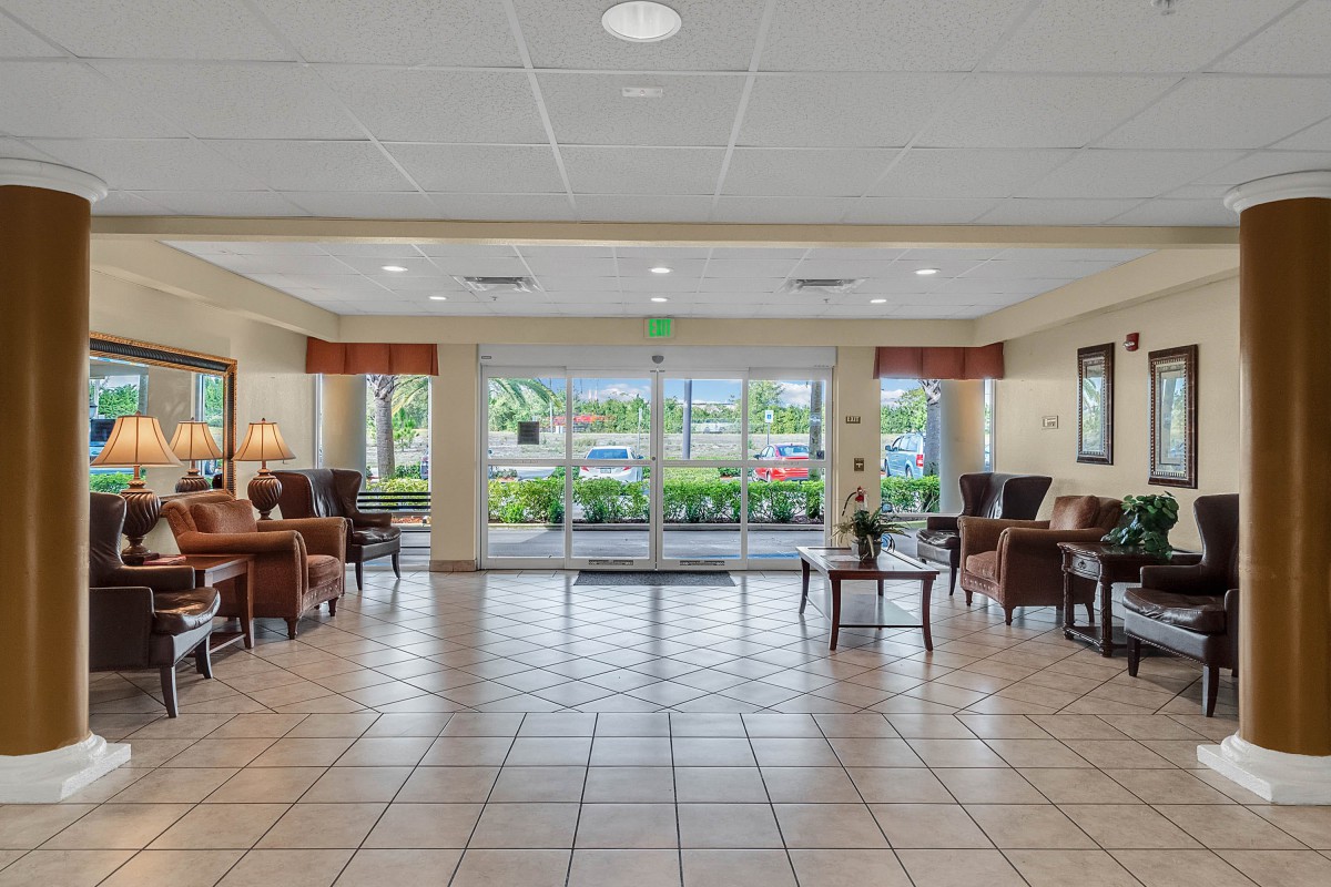 A spacious hotel lobby with ample seating and natural light filtering through large windows.