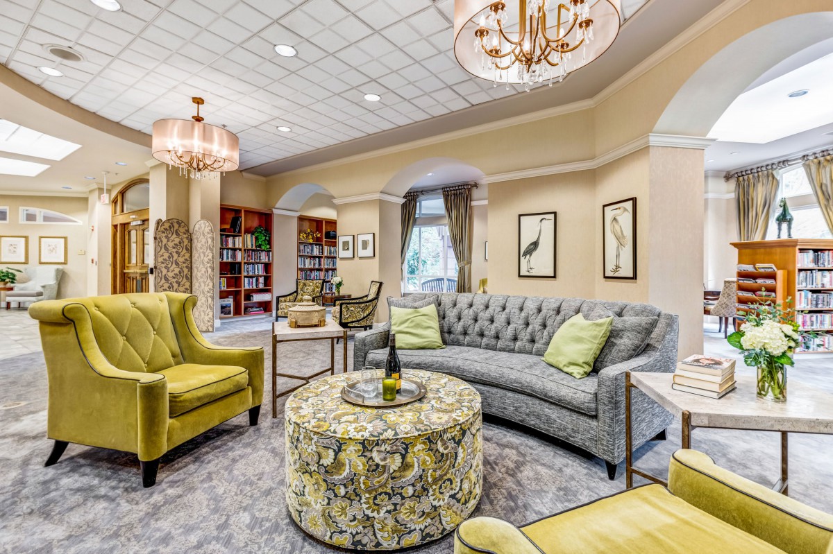 Elegant living room with stylish seating and chandeliers.