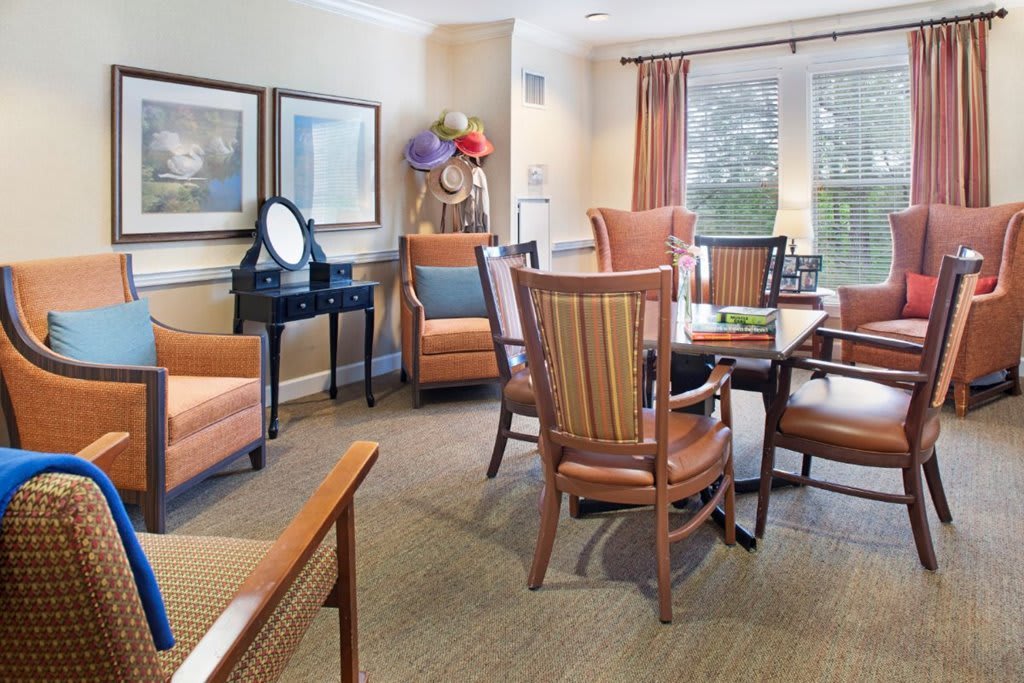 A cozy living room with comfortable chairs, a table, and soft lighting.