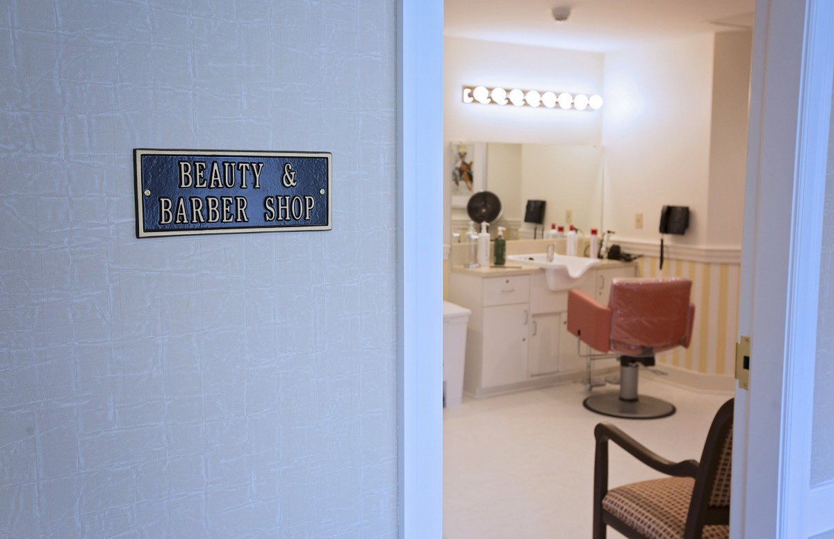 A beauty and barber shop with a stylish interior, showcasing hairdressing chairs and salon equipment.