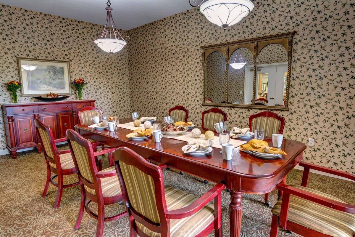 A cozy dining room with a set table and elegant decor.
