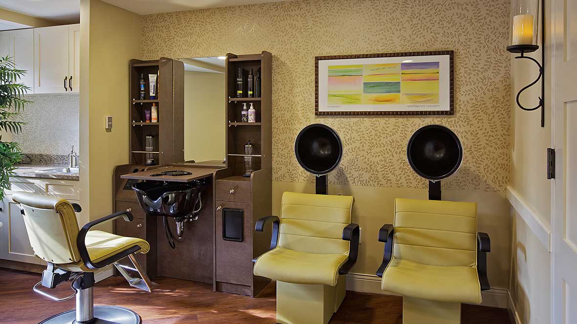 A cozy salon interior featuring styling chairs and hair dryers.