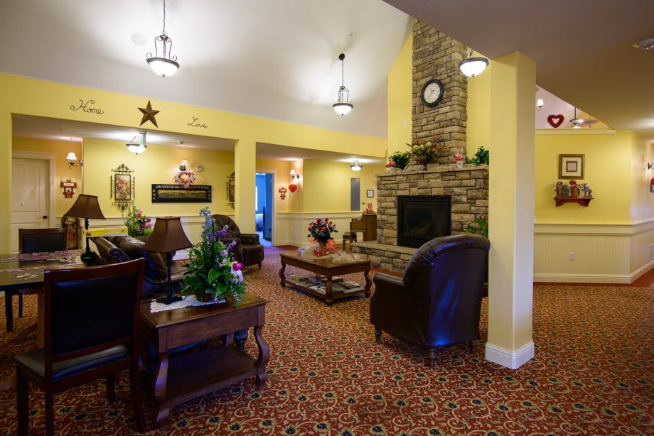 A cozy living room with comfortable seating and a brick fireplace.