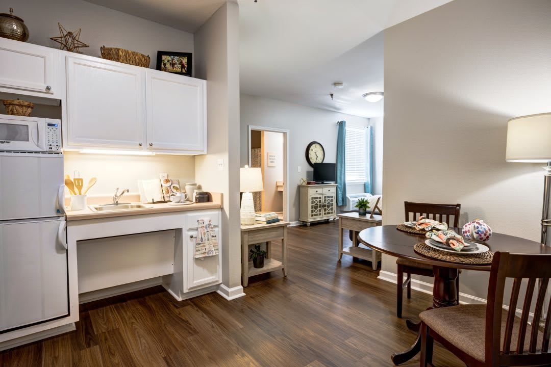 A cozy and modern interior featuring a small kitchen and dining area.