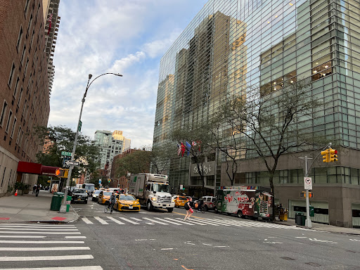 A busy NYC street scene with taxis and tall buildings.