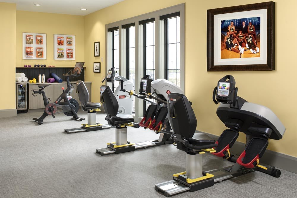 A well-equipped gym featuring several stationary bikes in a bright and spacious indoor setting.