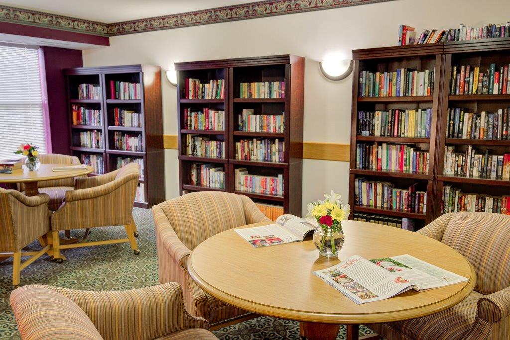 A cozy library reading area with bookshelves and comfortable seating.