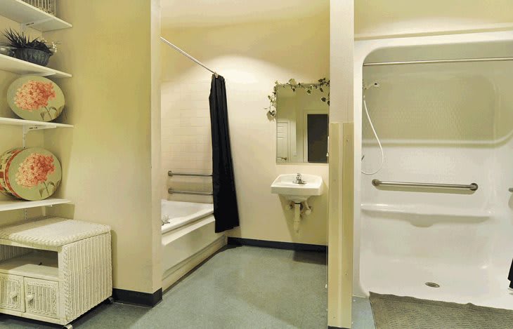 A modern bathroom with a bathtub, sink, and shower curtain.