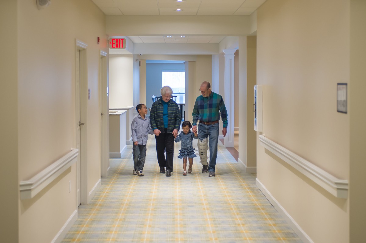 A family walking together down a hallway.