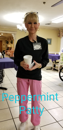 A person holding a drink in a casual indoor setting.