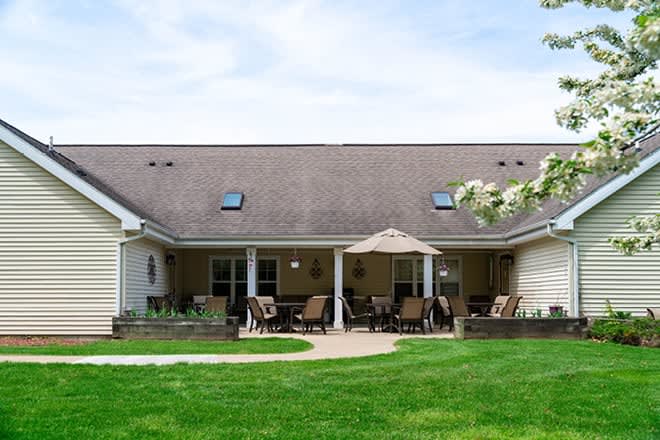 A suburban house with a well-maintained backyard and patio.