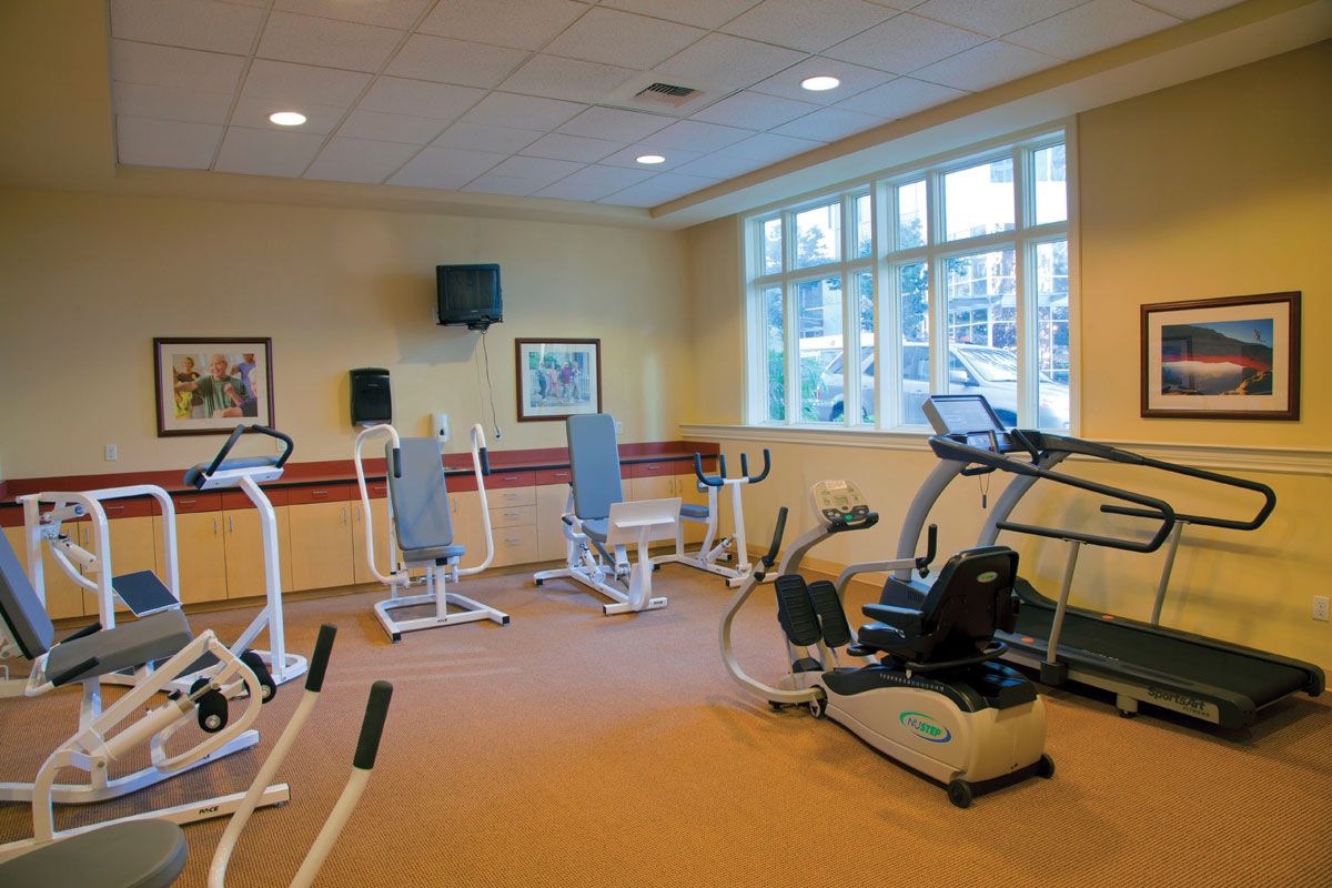 A well-equipped gym with various exercise machines and fitness equipment.