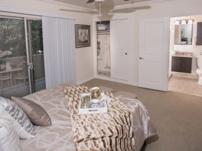A modern and cozy bedroom featuring neutral tones and minimalist decor.