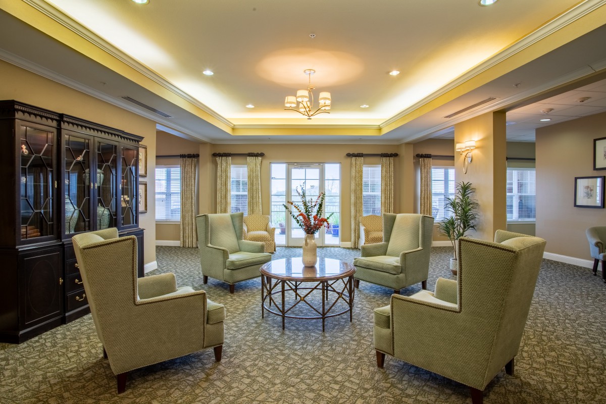 Elegant living room with plush seating and large windows.