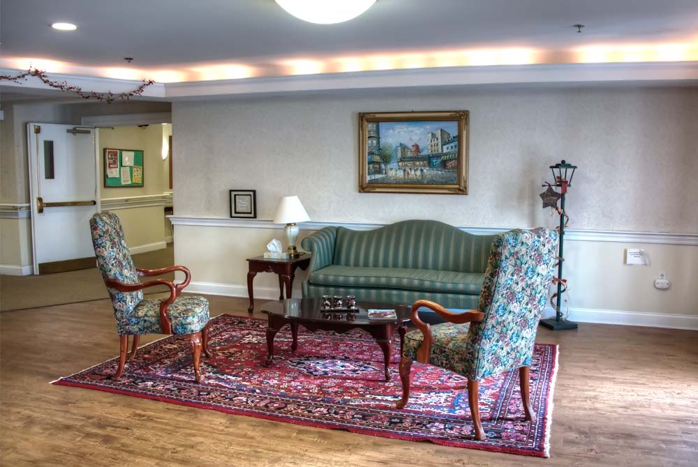 A cozy living room with classic furniture and artwork.