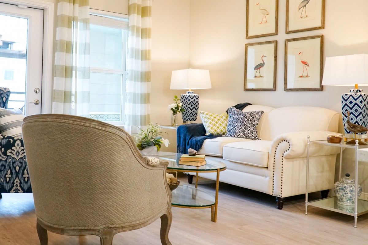 A cozy living room with a beige sofa, armchair, and stylish decor.