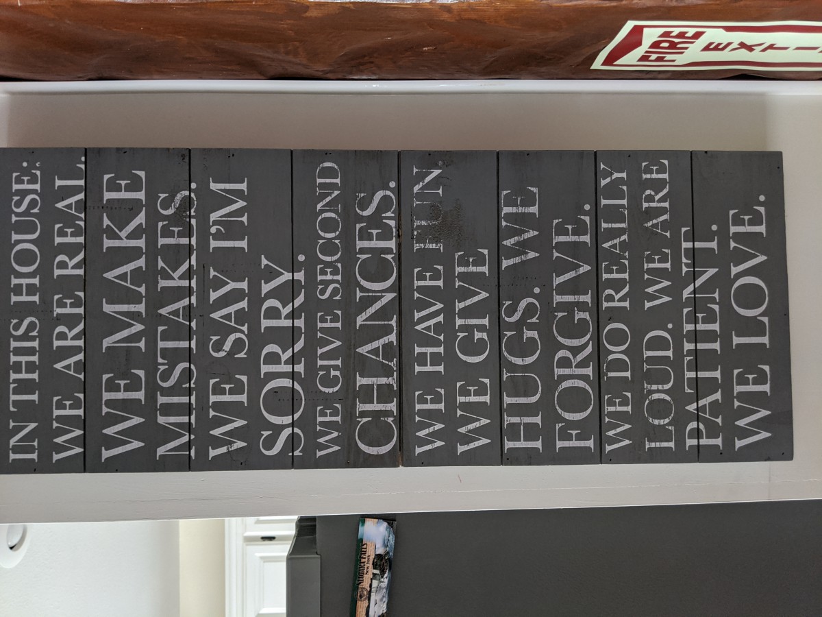 A wall sign displaying family values and inspirational quotes.