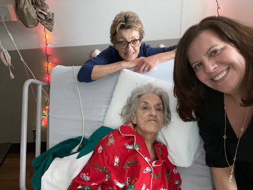 A heartfelt moment shared between family members in a hospital setting, showing love and support for the elderly patient.