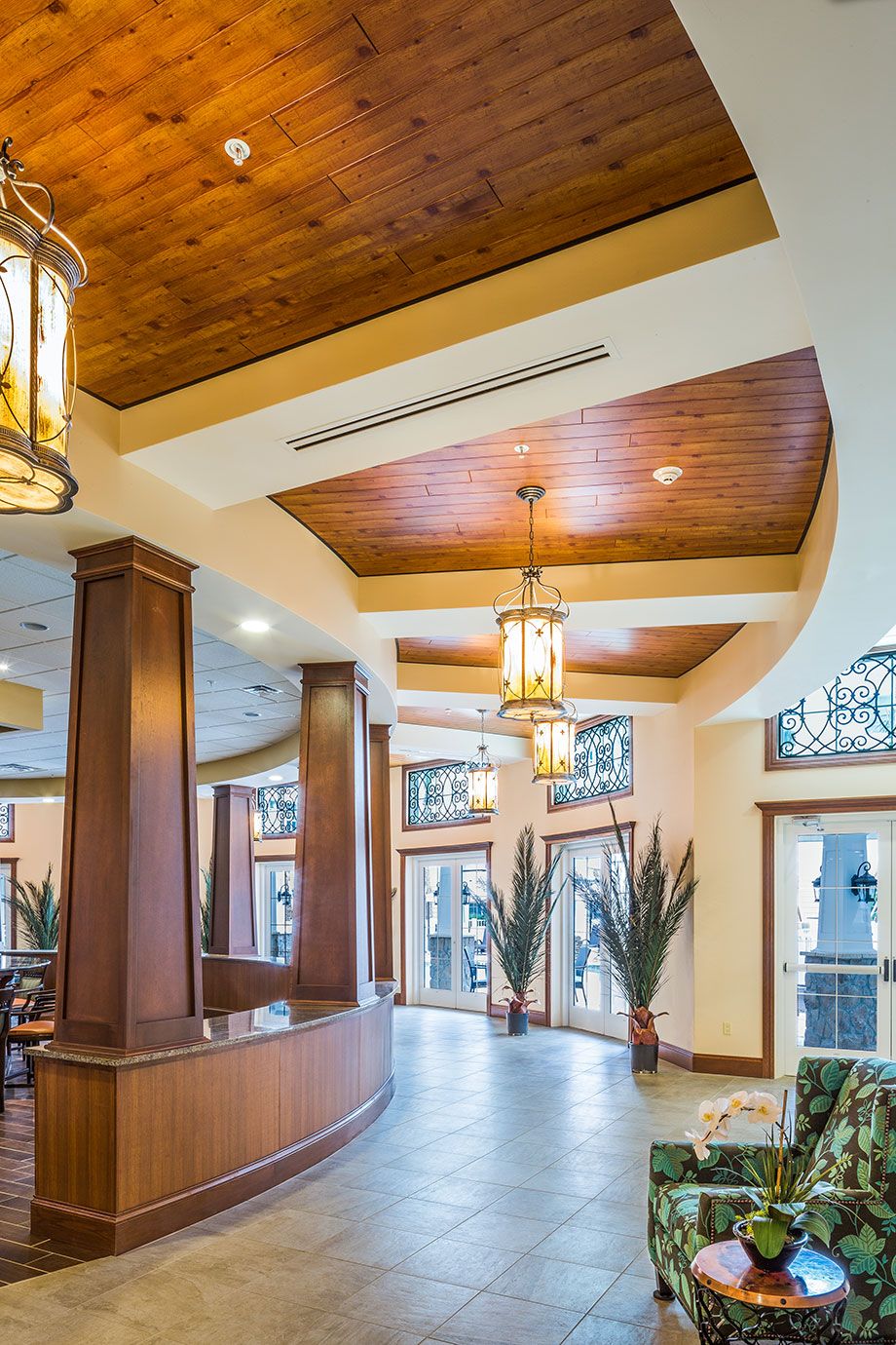 A modern hotel lobby with wooden accents and warm lighting.