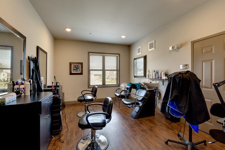 A cozy and modern hair salon with stylish chairs and large mirrors.