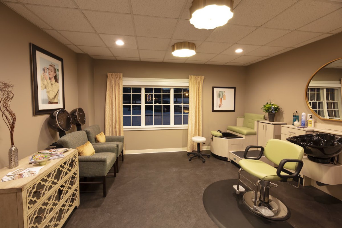 A cozy salon interior with modern decor and comfortable seating.
