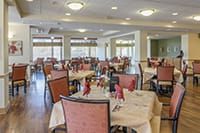 A spacious and elegantly arranged dining area with neatly set tables.