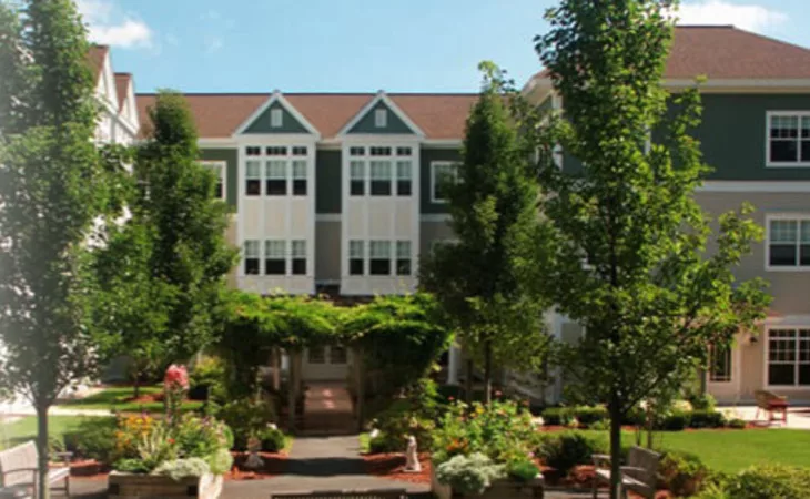 A picturesque building surrounded by lush greenery and a well-maintained garden.