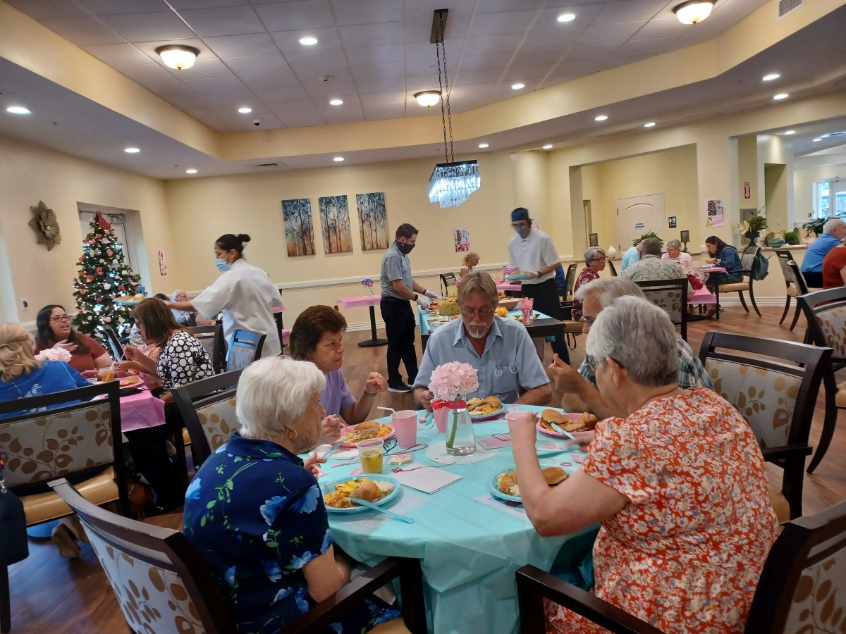 Residents enjoying a meal together in a communal dining area.