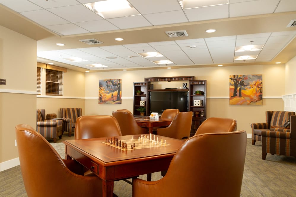 A cozy lounge area featuring comfortable seating and a chess board on the table.