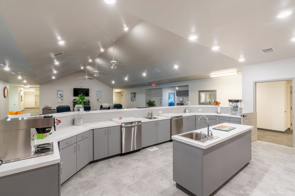 A spacious and modern kitchen with sleek countertops and bright lighting.