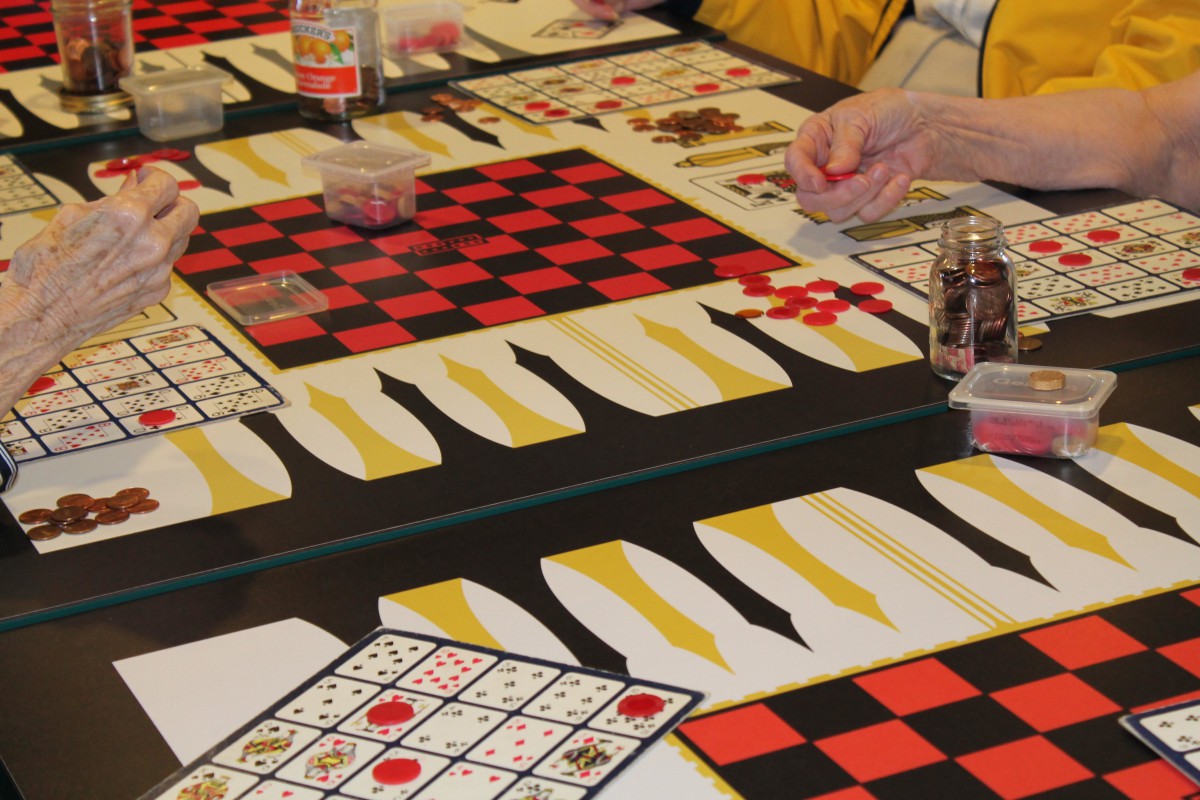 People playing board games, including checkers and bingo.