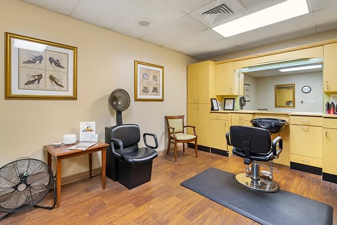 A cozy hair salon interior with a barber chair and waiting area.