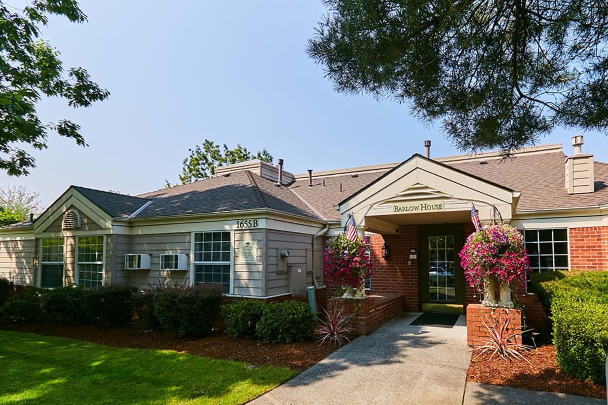A well-maintained residential house with manicured landscaping and a welcoming entrance.