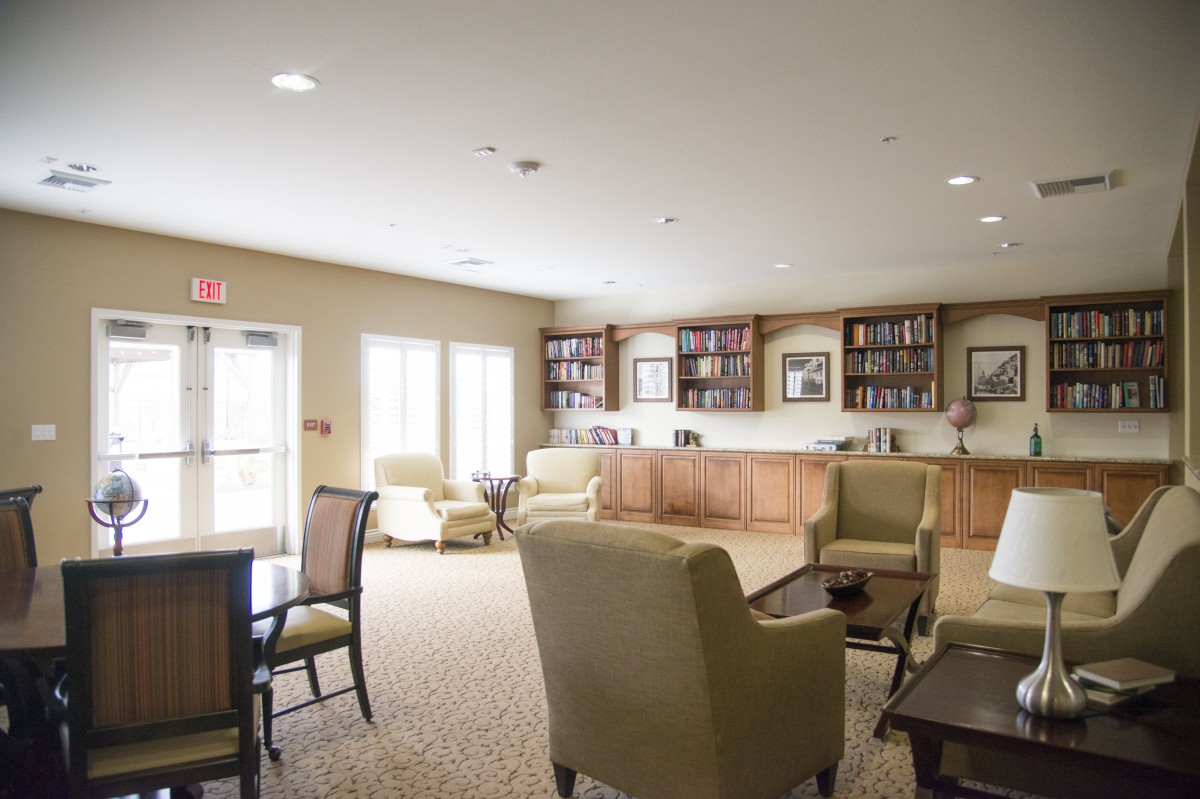 A cozy lounge area with comfortable seating and bookshelves.