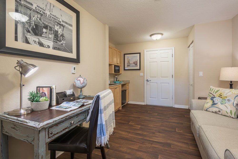 A cozy home office with a desk, chair, and decorative elements.