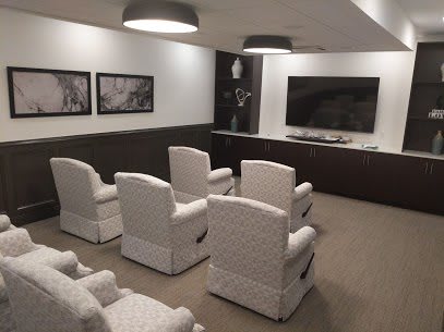 A cozy home theater setup with comfortable seating and a large screen.