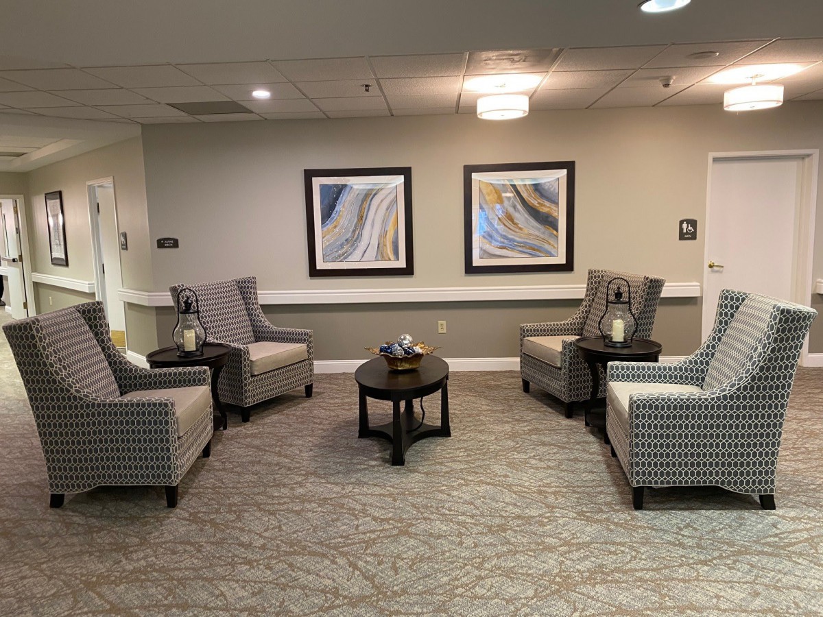A cozy waiting area with chairs and art on the walls.
