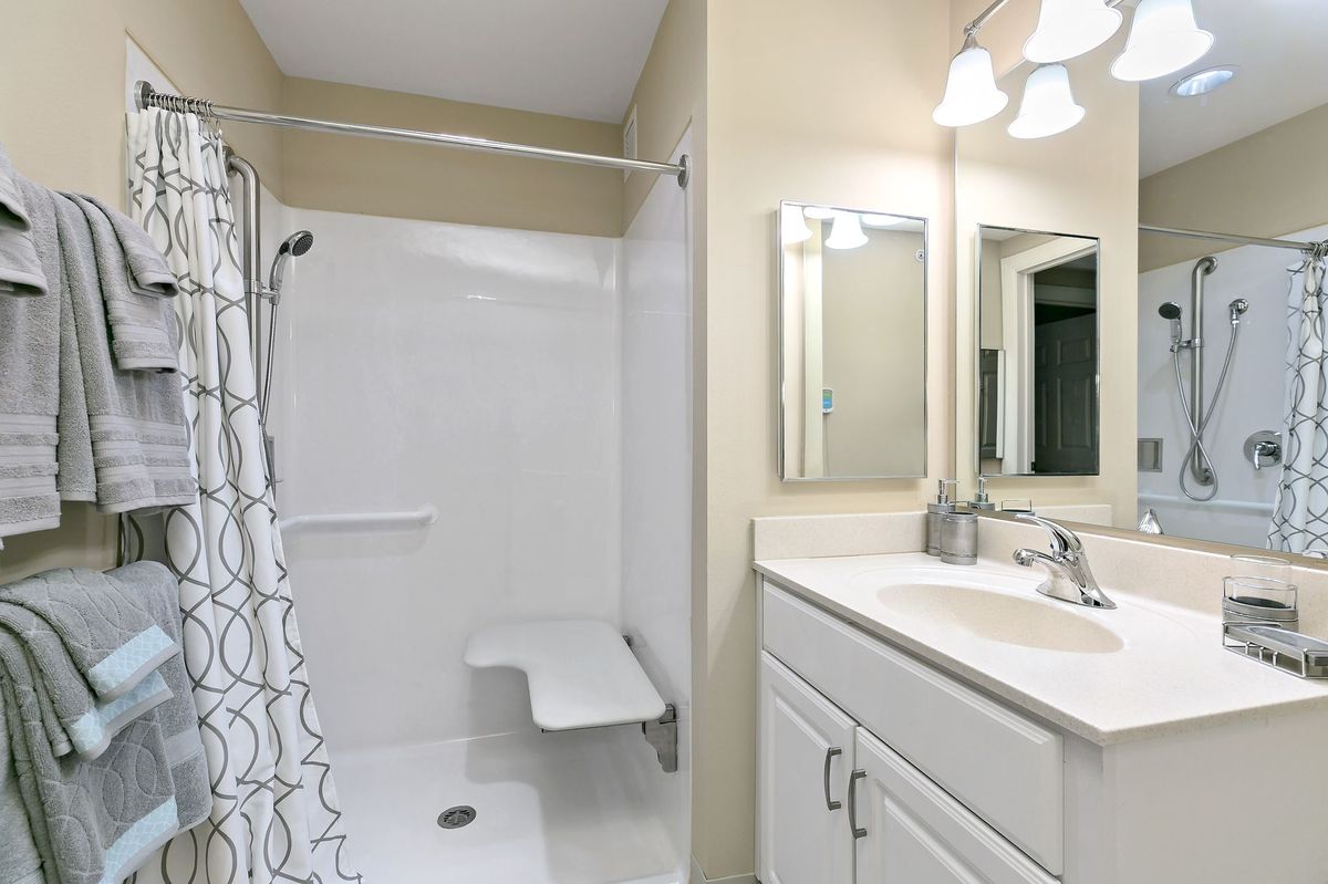 A modern bathroom with a shower and sink area.