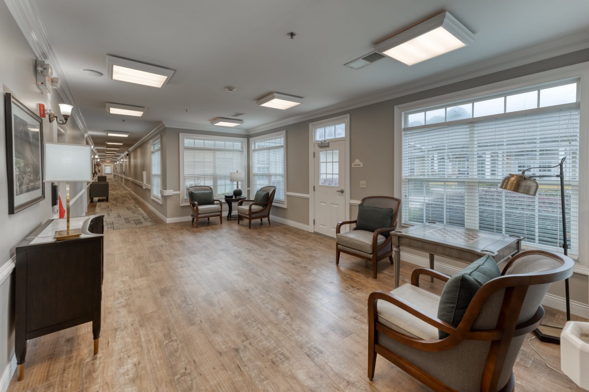 A spacious hallway with comfortable seating and large windows allowing natural light.