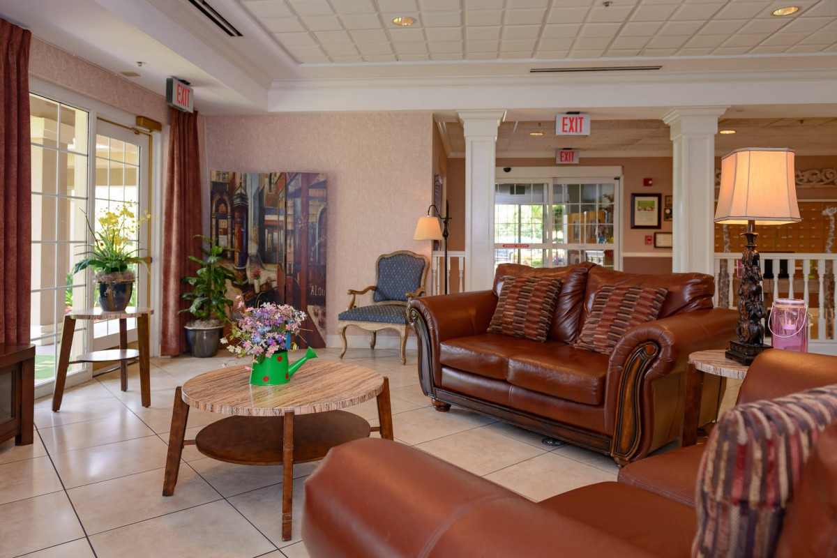 A cozy living room with leather sofas and elegant decor.