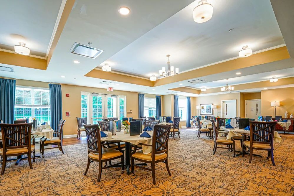 A spacious and well-lit dining area with elegant decor and comfortable seating.