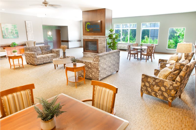 A spacious and modern lounge area with comfortable seating and large windows.